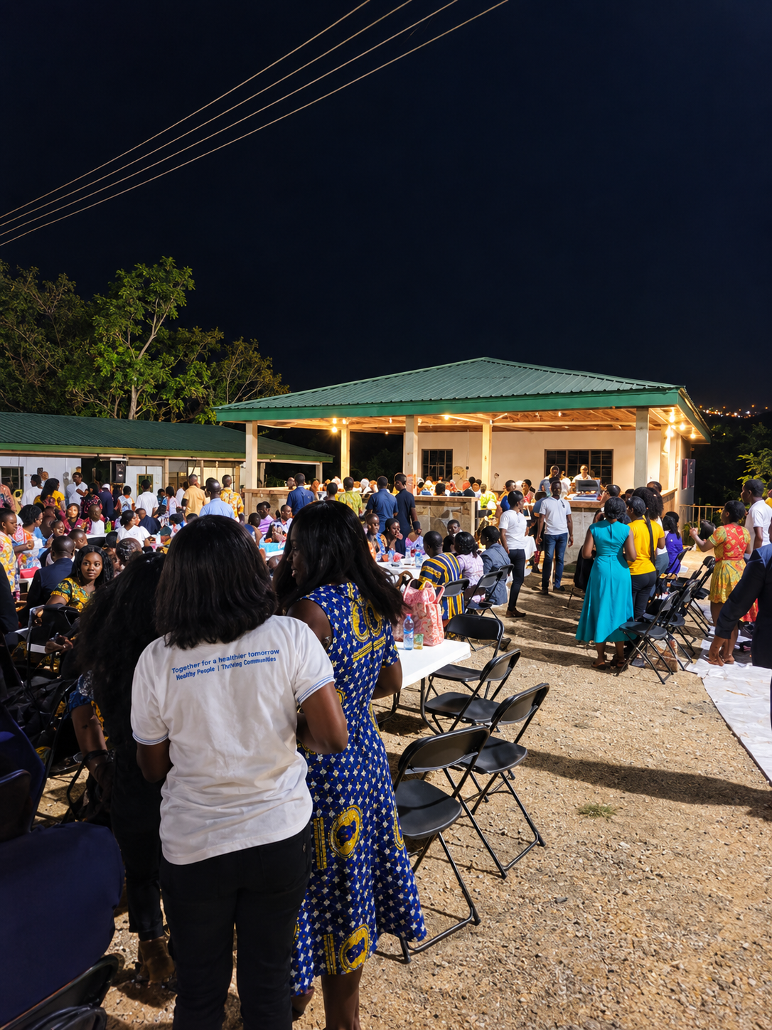 Large community gathering at night in the outdoor pavilion at Tetra Jungle Hotel