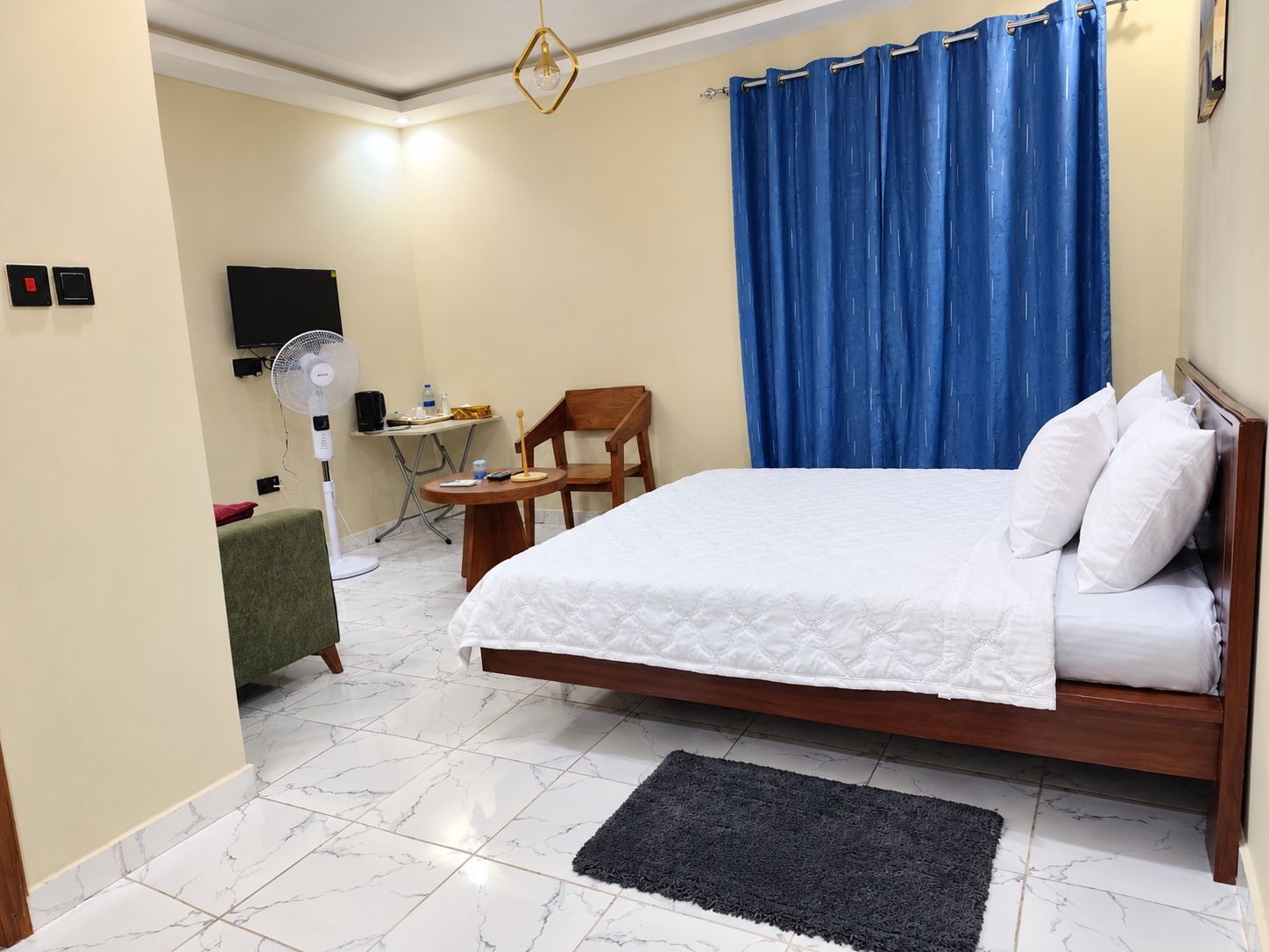 Hotel bedroom with blue curtains